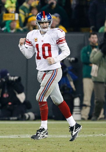 Eli Manning looks far from impressed as brother Peyton wins Super