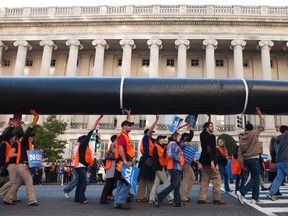 Demonstrators carry a giant mock pipeline while calling for the cancellation of the Keystone XL pipeline during a rally in front of the White House in Washington November 6, 2011.  Protesters are unhappy about TransCanada Corp's  plan to build the massive pipeline to transport crude from Alberta, Canada, to Texas.  (REUTERS)