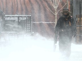 Snow removal workers like Oliver Carino in downtown Calgary had to bundle up as temperatures plummeted, Tuesday, January 17  2012. DARREN MAKOWICHUK/QMI AGENCY