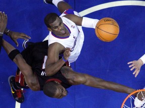 Los Angeles Clippers' Chris Paul (right) puts up a shot past Miami Heat's Chris Bosh during a game last week. (REUTERS)