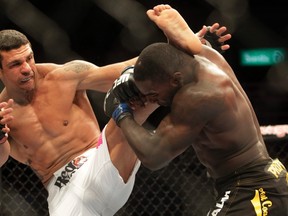 Vitor Belfort of Brazil (left) fights with Anthony Johnson of the U.S. during UFC142 in  Rio. Johnson was fired after the fight. (REUTERS)