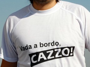 A man wears a T-shirt with a message that is equivalent to "Go on board, damn it" in downtown Naples January 18, 2012.  (REUTERS/Ciro De Luca)