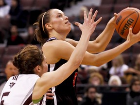 Carleton Ravens Alyson Bush drives to the net past the Ottawa Gee-Gee defender Teddi Firmi during play at the MBNA Capital Hoops Classic at Scotibank Place. Wednesday January 18,2012. (ERROL MCGIHON/THE OTTAWA SUN/QMI AGENCY).