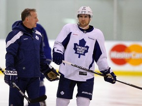 Maple Leafs head coach Ron Wilson (left) talks with Matthew Lombardi during the team's workout Wed. Jan. 18, 2012 at the MasterCard Centre. (Michael Peake/Toronto Sun)