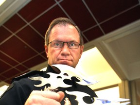 Staff Sgt. Steve Young displays some seized edged weapons. PERRY MAH/Edmonton Sun