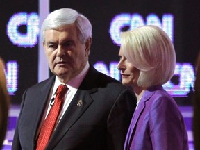 Republican presidential candidate former House Speaker Newt Gingrich (L) holds hands with wife Callista on stage after a Republican presidential candidates debate in Charleston, South Carolina, January 19, 2012. (REUTERS/Jason Reed)
