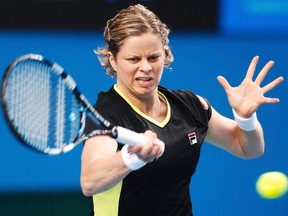 Kim Clijsters hits a return to Daniela Hantuchova during their women's singles match at the Australian Open in Melbourne on Friday, Jan. 20, 2012. (REUTERS/Daniel Munoz)