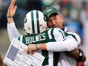 New York Jets' offensive coordinator Brain Schottenheimer congratulates Santonio Holmes after he made a catch for the winning touchdown against the Buffalo Bills in the fourth quarter of their NFL game in East Rutherford, New Jersey, Nov. 27, 2011. (REUTERS/Ray Stubblebine)