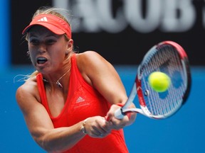 Caroline Wozniacki of Denmark hits a return to Monica Niculescu of Romania during their women's singles match at the Australian Open tennis tournament in Melbourne, Jan. 20, 2012.  (REUTERS/Daniel Munoz)