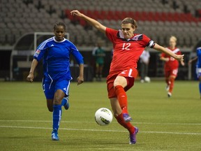 Canada's Christine Sinclair shoots to score her third goal during the second half of their CONCACAF Women's Olympic qualifying soccer game against Haiti in Vancouver, British Columbia Jan. 19, 2012.  (REUTERS/Andy Clark)