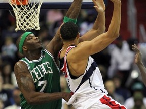 Boston Celtics' Jermaine O'Neal attempts to block Washington Wizards' JaVale McGee during the first half of their NBA basketball game in Washington, Jan. 22, 2012. (REUTERS/Gary Cameron)