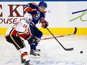 Taylor Hall is harassed by Jarome Iginla during the second period of the Edmonton Oilers 6-2 loss to the Calgary Flames Saturday at Rexall Place.
Codie McLachlan, Edmonton Sun