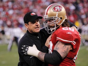 San Francisco 49ers head coach Jim Harbaugh congratulates Adam Snyder after the 49ers defeated the New Orleans Saints in their NFC divisional playoff football game in San Francisco last Saturday. (REUTERS)