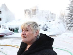Resident Patricia Hunt surveys the scene following the Jan. 19, 2012 fire at the Heatheridge Estates condos near 111 Street and 18 Avenue, Friday  20, 2012.  Hunt and her husband say they lost everything in the fire. DAVID BLOOM EDMONTON SUN