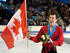 Patrick Chan skates with a Canadian flag after being presented with his gold medal at the Canadian championships yesterday. (REUTERS)