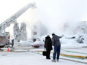 Resident Patricia and Robert Hunt survey the scene following the Jan. 19, 2012 fire at the Heatheridge Estates condos near 111 Street and 18 Avenue, Friday  20, 2012.  The Hunts say they lost everything in the fire. DAVID BLOOM EDMONTON SUN  QMI AGENCY