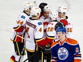 Ladislav Smid skates past as the Flames celebrate a goal during the third period of the Edmonton Oilers 6-2 loss at Rexall Place on Saturday.
Codie McLachlan, Edmonton Sun