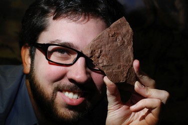 David Evans, associate curator at the Royal Ontario Museum,  holds one of the displayed finds showing tiny footprints.  The ROM held a press conference on Monday January 23, 2012,  displaying new fossil specimens from the field in South Africa, including unveiling of a dinosaur baby foot print and nest. The newly unearthed dinosaur nesting ground predates previously known nesting site ever found by 100 million years, according to the authors.  (Craig Robertson, Toronto Sun)