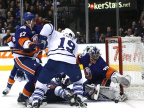 Leafs winger Joffrey Lupul is stopped by Islanders goalie Evgeni Nabokov during Monday night's game. (MICHAEL PEAKE/Toronto Sun)