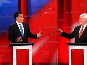 Republican presidential candidate former Massachusetts Governor Mitt Romney (L) and former Speaker of the House Newt Gingrich speak at the Republican presidential candidates debate in Tampa, Florida January 23, 2012.  REUTERS/Scott Audette