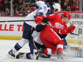 Red Wings forward Darren Helm battles in the crease with Blues forward Jason Arnott at Joe Louis Arena in Detroit, Mich., Jan. 23, 2012. (DAVE SANDFORD/Getty Images/AFP)