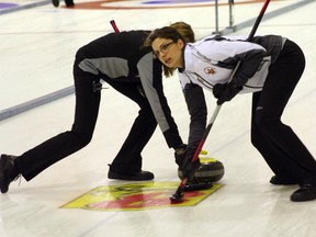 Lisa Weagle, lead for the Homan rink, sweeps during a match against the McCarville rink at the Ontario Scotties Tournament of Hearts at the Kenora Curling Club in Kenora, Ont., Jan. 23, 2012. (GARETT WILLIAMS/QMI Agency)