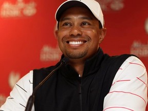 Tiger Woods smiles during a news conference at the Abu Dhabi HSBC Golf Championship in the United Arab Emirates on Tuesday, Jan. 24, 2012. (REUTERS)
