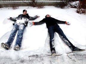 Oil Kings Mark Pysyk and Keegan Lowe make some angels in the snow.  The Edmonton Oil Kings helped shoves some sidewalks on 108 Avenue and 128 Street Tuesday.  The team is partnering up with the city's Snow Angel Program.  People who help shovel their neighbour's  sidewalks can be nominated and they can receive tickets to a Oil Kings game.  PERRY MAH/EDMONTON SUN