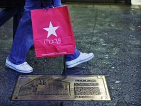 Shoppers walk outside Macy's department store in New York January 12, 2012. (REUTERS/Eduardo Munoz)