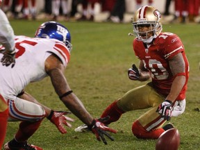New York Giants wide receiver Devin Thomas (left) recovers a fumble by San Francisco 49ers wide receiver Kyle Williams in overtime Sunday. The turnover helped the Giants advance to the Super Bowl. (REUTERS)