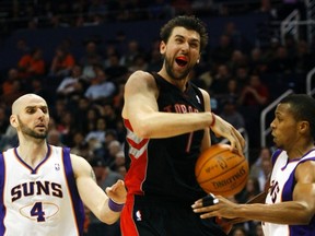 Raptors' Andrea Bargnani is fouled on his way to the basket against the Phoenix Suns during Tuesday night's game. (Reuters)
