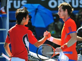 Kei Nishikori of Japan (L) shakes hands with Andy Murray of Britain after their men's singles quarter-final match at the Australian Open tennis tournament in Melbourne January 25, 2012.  (REUTERS/Toby Melville)