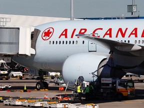 An Air Canada Boeing 777 is refuelled in this July 28, 2011 file photo. (REUTERS FILES/Tim Wimborne)