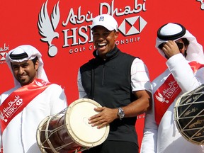 Tiger Woods laughs as he plays a traditional drum with an Emirati dance troupe as a preview for the Abu Dhabi Golf Championship at the Abu Dhabi Golf Club this week. The former world number one says he is in the best shape physically at the start of the season in more than a decade as he arrived in the UAE capital for the Abu Dhabi competition. (AFP PHOTO/KARIM SAHIB)