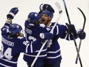 Toronto Maple Leafs' Clarke MacArthur (right) celebrates with his teammates Nazem Kadri (centre) and Mikhail Grabovski after his overtime goal against the New York Islanders Wednesday night on Long Island. (REUTERS)
