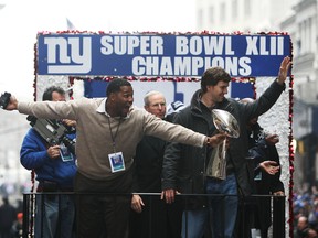 Michael Strahan, head coach Tom Coughlin and Eli Manning of the New York Giants ride in a float along Broadway, also known as "The Canyon of Heroes" during Super Bowl XLII victory parade in New York City, on Feb. 5, 2008. (GETTY IMAGES)