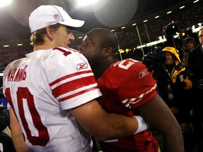 Giants quarterback Eli Manning is congratulated by 49ers running back Frank Gore after the NFC championship game in San Francisco, Calif., Jan. 22, 2012. (ROBERT GALBRAITH/Reuters)