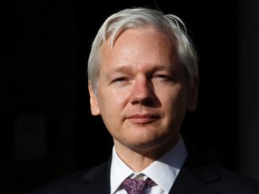 WikiLeaks founder Julian Assange speaks to the media outside the High Court in London in this December 5, 2011 file photo. (REUTERS/Suzanne Plunkett)