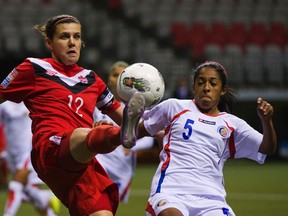 Costa Rica's Diana Saenz and Canada's Christine Sinclair go for the ball during their CONCACAF women's Olympic qualifying match in Vancouver, B.C., Jan. 23, 2012. (ANDY CLARK/Reuters)