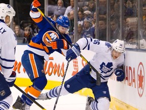 Islanders Josh Bailey battles Leafs defenceman Carl Gunnarsson for the puck during Monday's Toronto win at the ACC. (REUTERS)