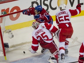 Canadiens forward Rene Bourque flies into the Red Wings net as he scores on goaltender Jimmy Howard at the Bell Centre in Montreal, Que., Jan. 25, 2012. (PIERRE-PAUL POULIN/QMI Agency)
