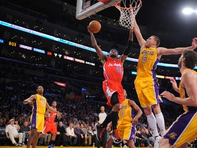 Clippers guard Mo Williams takes a shot against Lakers forward Josh McRoberts at the Staples Center in Los Angeles, Calif., Jan. 25, 2012. (NOAH GRAHAM/NBAE via Getty Images/AFP)