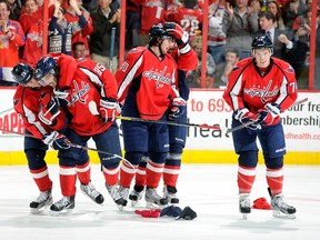 Capitals forward Mathieu Perreault (second left) celebrates his hat trick against the Bruins with teammates at the Verizon Center in Washington, D.C., Jan. 24, 2012. (GREG FIUME/Getty Images/AFP)