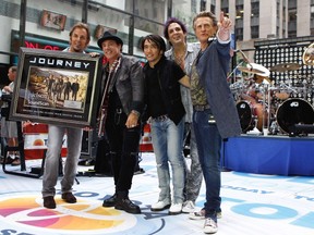 Journey band members (L-R) Jonathan Cain, Neal Schon, Arnel Pineda, Deen Castronovo, and Ross Valory pose together after performing on NBC's Today Show in New York July 29, 2011.  REUTERS/Lucas Jackson