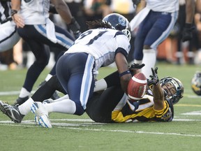 Argo defensive back Lin-J Shell unloads on Hamilton receiver Chris Williams during action last season. The Argos released Shell Thursday, due to salary cap concerns. (JACK BOLAND/Toronto Sun)