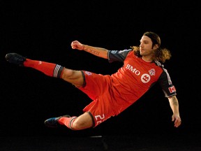 Toronto FC's new captain,Torsten Frings, jumps for a promotional photo during Thursday's team media day at the ACC. (MIKE PEAKE/Toronto Sun)
