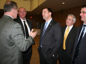 Ontario Progressive Conservative leader Tim Hudak, centre, listens as Northern College president Fred Gibbons, left, makes a point following Hudak's speech at a Timmins Chamber of Commerce luncheon at the Dante Club Wednesday. (RON GRECH/QMI AGENCY)