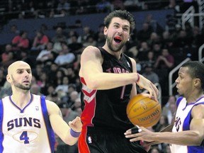 Raptors’ Andrea Bargnani gets fouled by Suns point guard Sebastian Telfair (right) during Toronto’s Tuesday night win in Phoenix. (REUTERS)