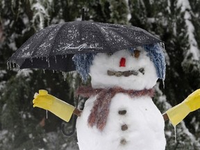 A snowman with an umbrella is covered in ice in a Renton, Washington neighborhood, January 19, 2012.  Ice storms have caused power outages and downed trees throughout the Puget Sound region and have been responsible for at least one death near Issaquah, Washington. REUTERS/Robert Sorbo (UNITED STATES - Tags: ENVIRONMENT TPX IMAGES OF THE DAY)