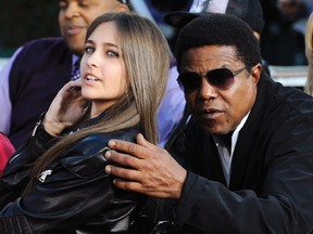 Michael Jackson's daughter Paris (L) and brother Tito Jackson. (REUTERS/Phil McCarten)